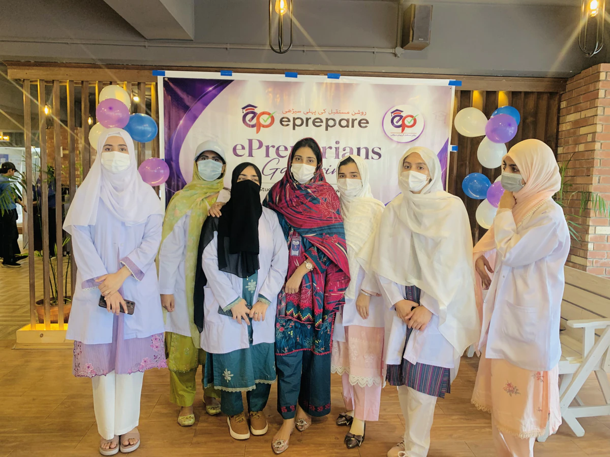 Students standing in front of the ePreparians get-together banner