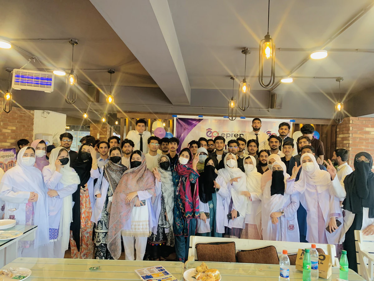 Students raising their hands and cheering at the ePreparians get-together in Peshawar